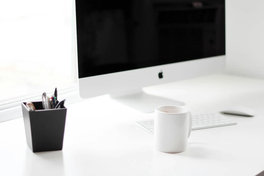 A cup of coffee and desktop on a desk