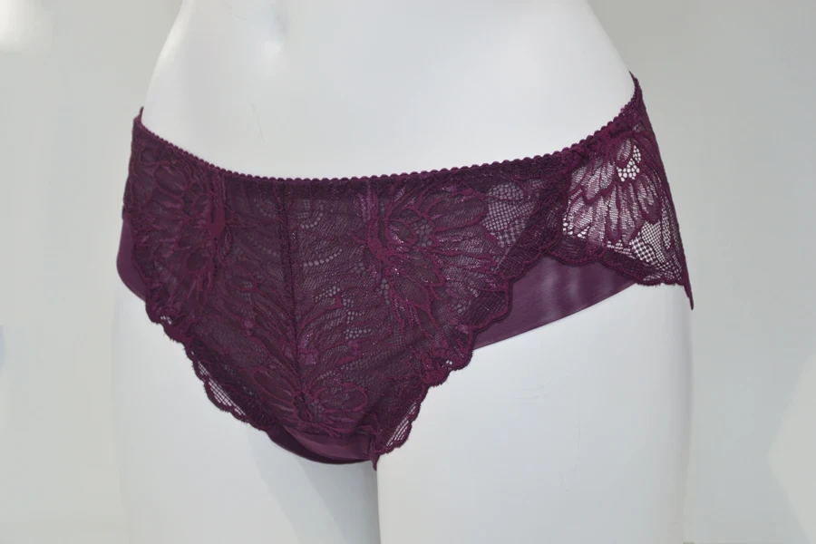 A dark plum lace brief on a mannequin