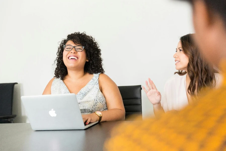 A group of women sitting at a table laughing