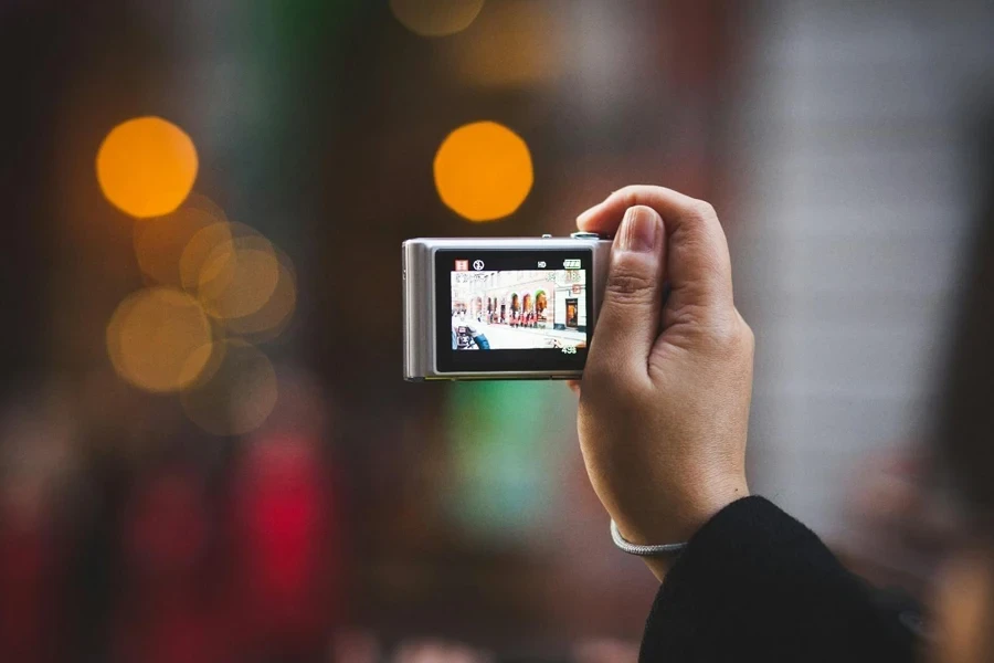 A hand holding a camera