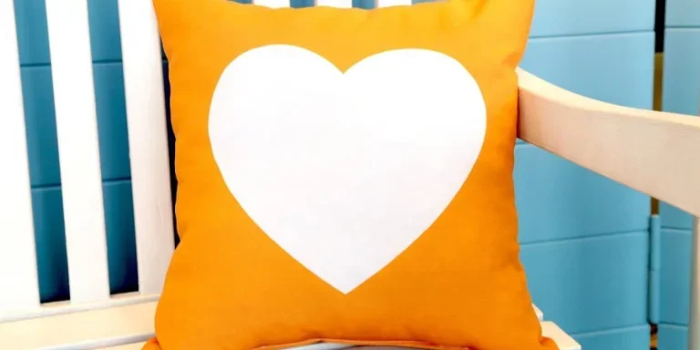 A heart shaped pillow on a chair