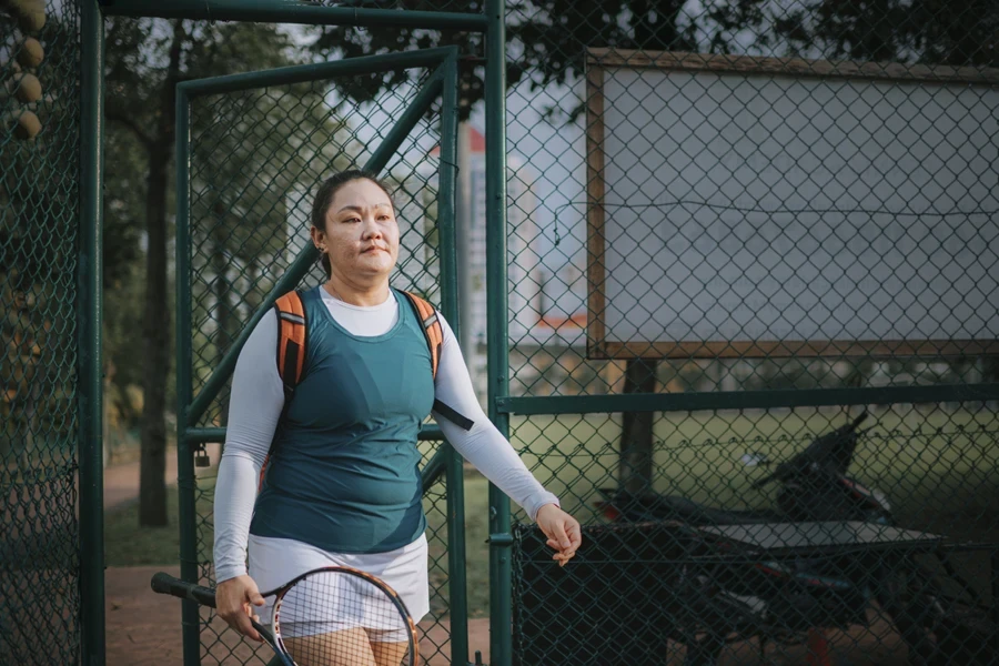 A lady entering a court in a layered tennis skirt