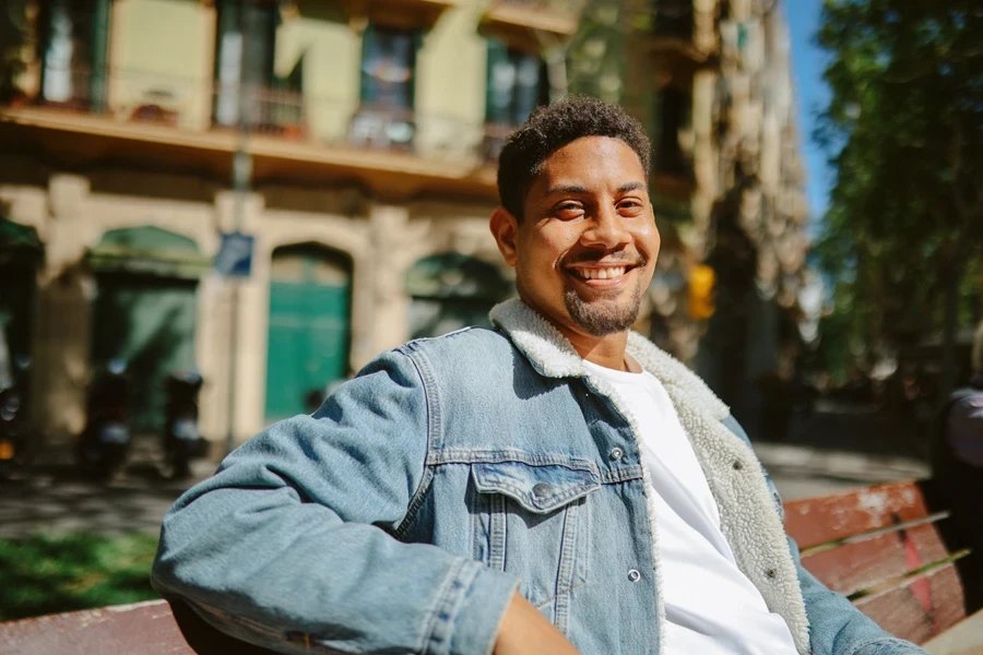 A man in a fur-lined denim jacket during the day