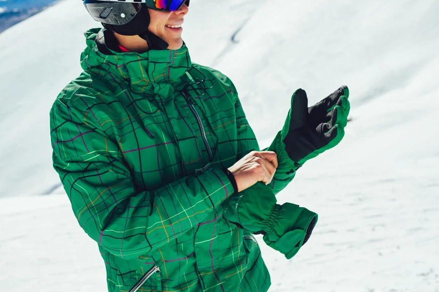 A man wearing waterproof ski gloves on the slopes