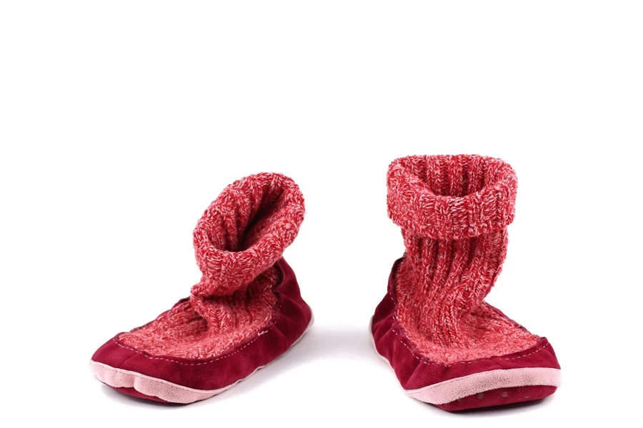 A pair of red slipper socks on a white background