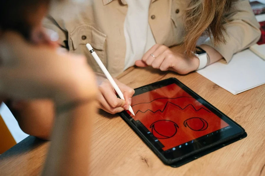 A person drawing on a tablet