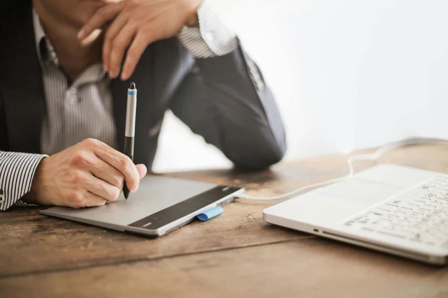 A person using a stylus on a tablet