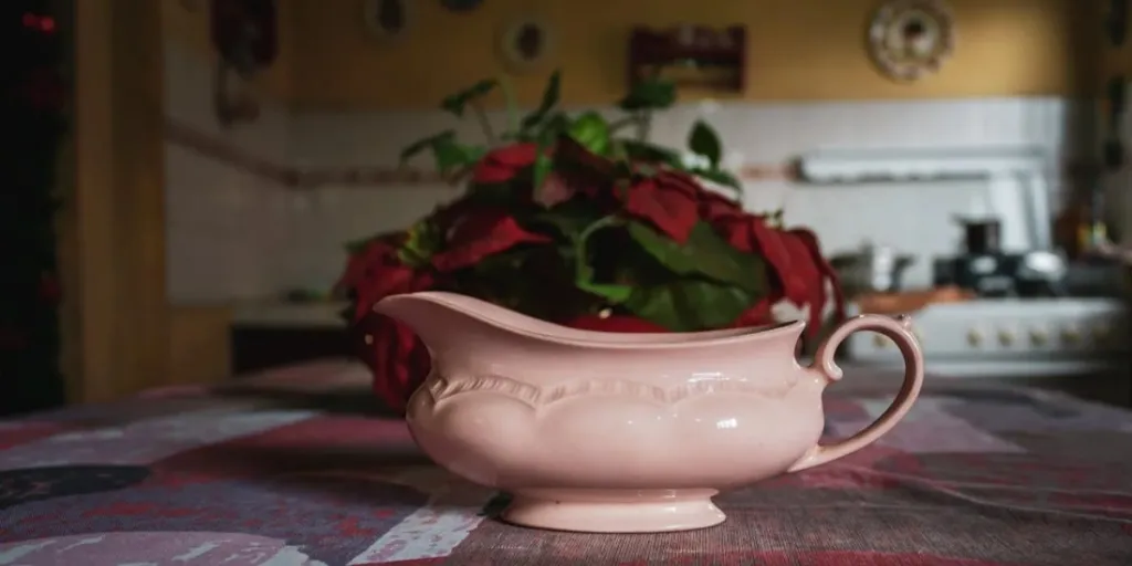 A pink gravy boat on a dinner table