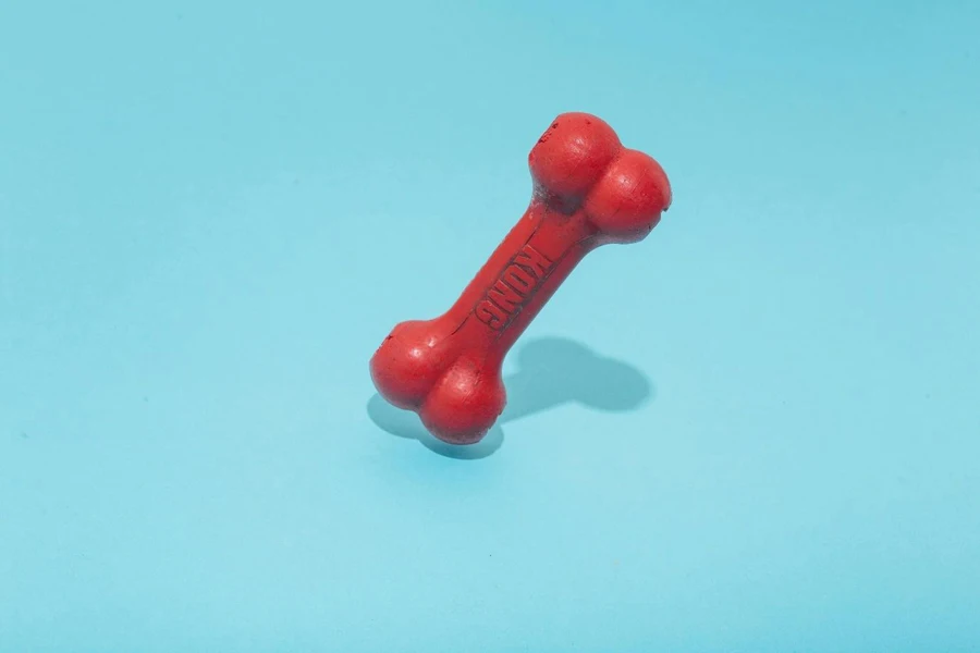 A red dog bone on a blue background