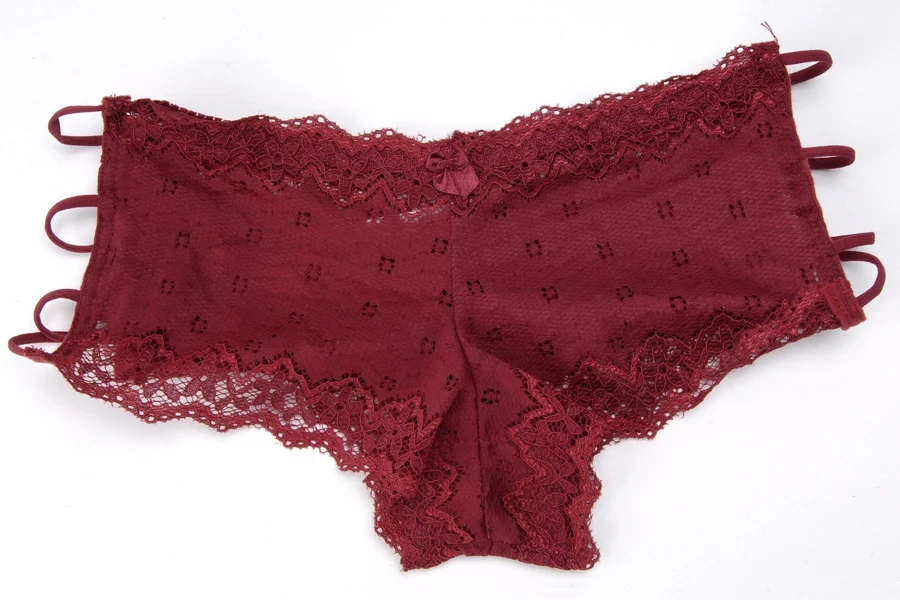 A red lace hipster panty on a white background