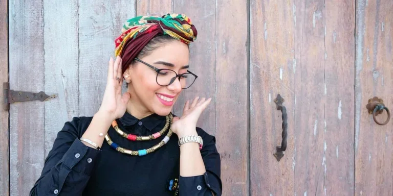 A smiling woman wearing a headscarf