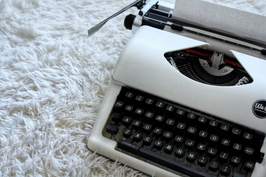 A typewriter on a white carpet