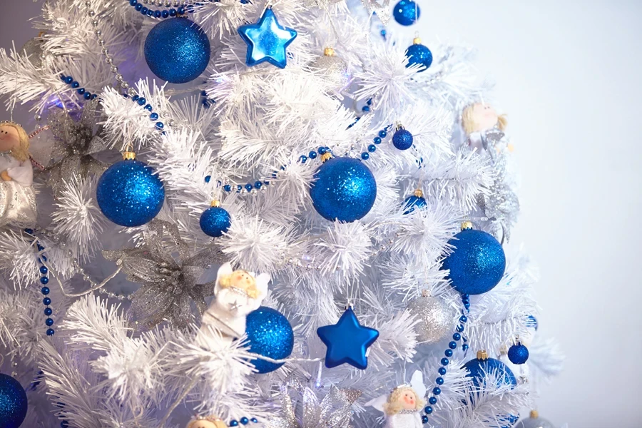 A white Christmas tree with blue and white ornaments