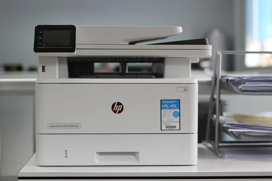 A white printer on a desk