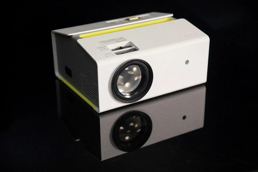 A white projector with a lens