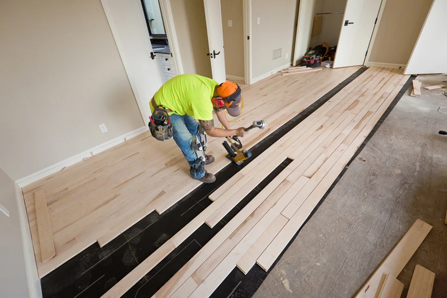 A workman installing a maple hardwood floor