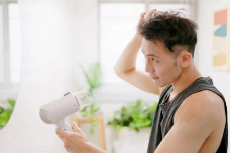 Asian Man Use Hair Dryer