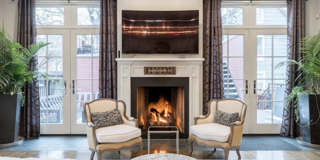 Beautiful living room with chairs, plants and fireplace