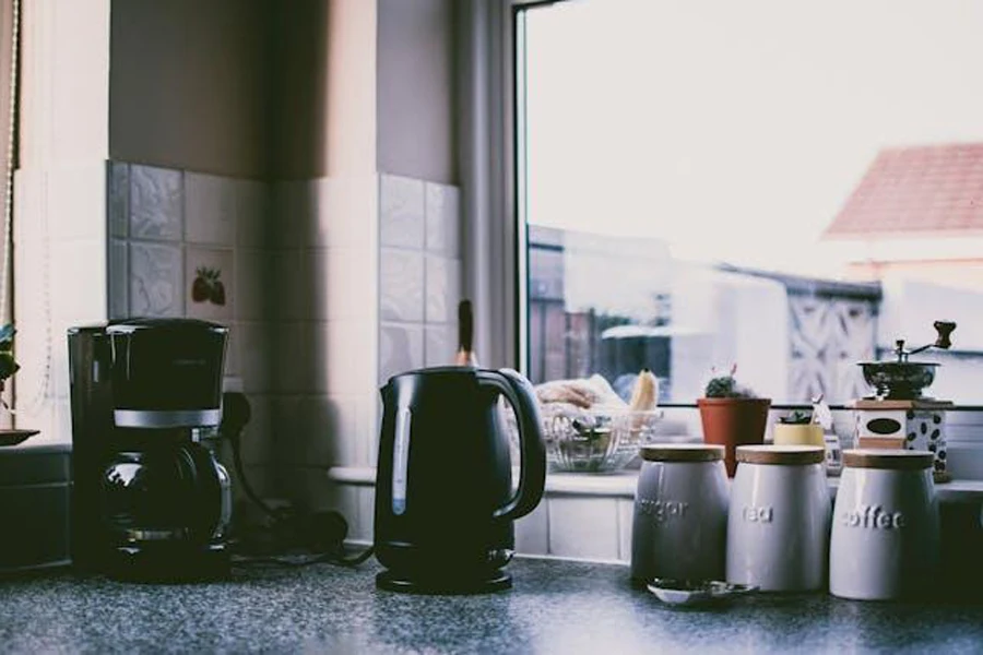 Black coffee maker and kettle with tea canisters