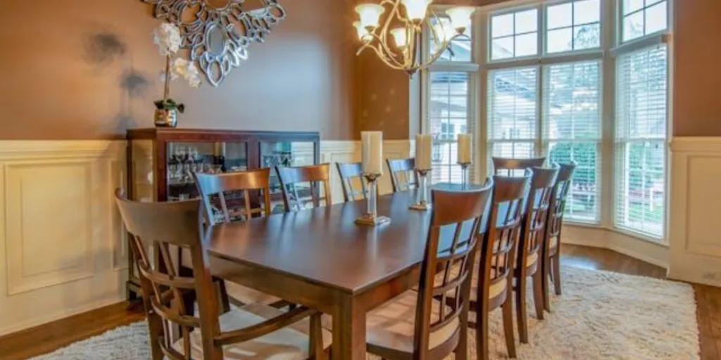 Brown wooden dining table with chairs and chandelier