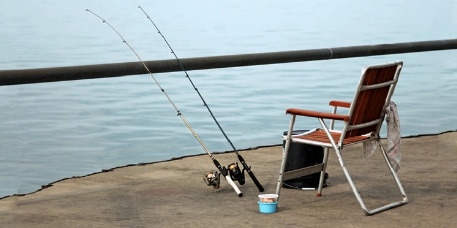 Chairs, fishing poles and bait on the lake