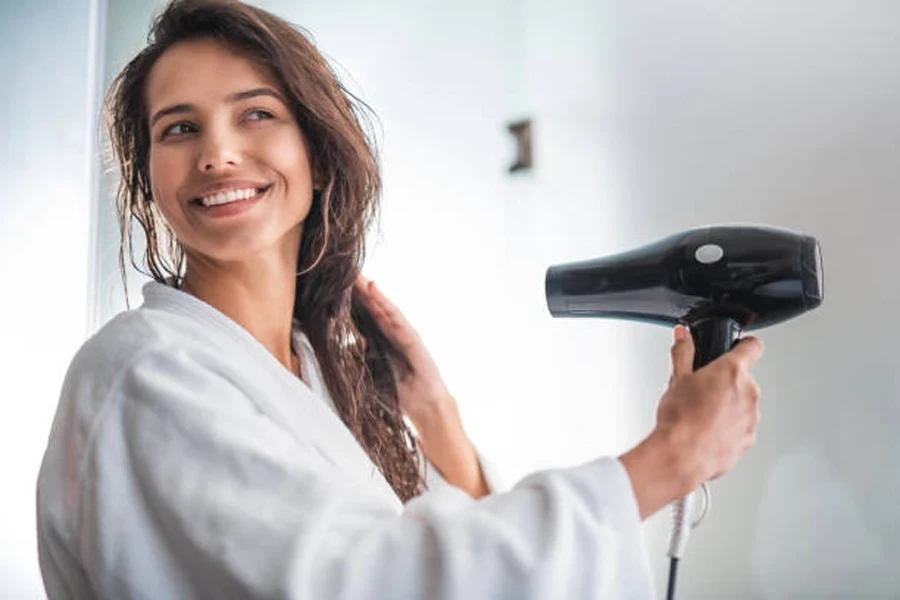 Cheerful Lady Drying Hair with Appliance