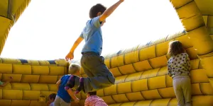 Children Playing on Inflatable Castle