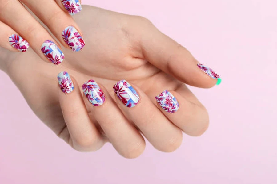 Colorful nails painted with flowers for summer vibes