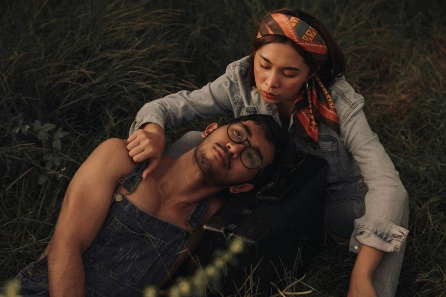 Couple Relaxing On Grassland