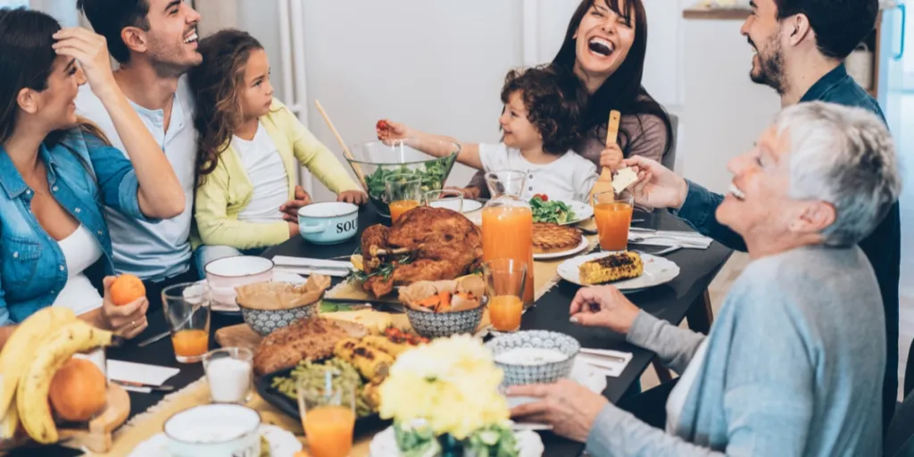 Family enjoying a great time at a Thanksgiving dining table