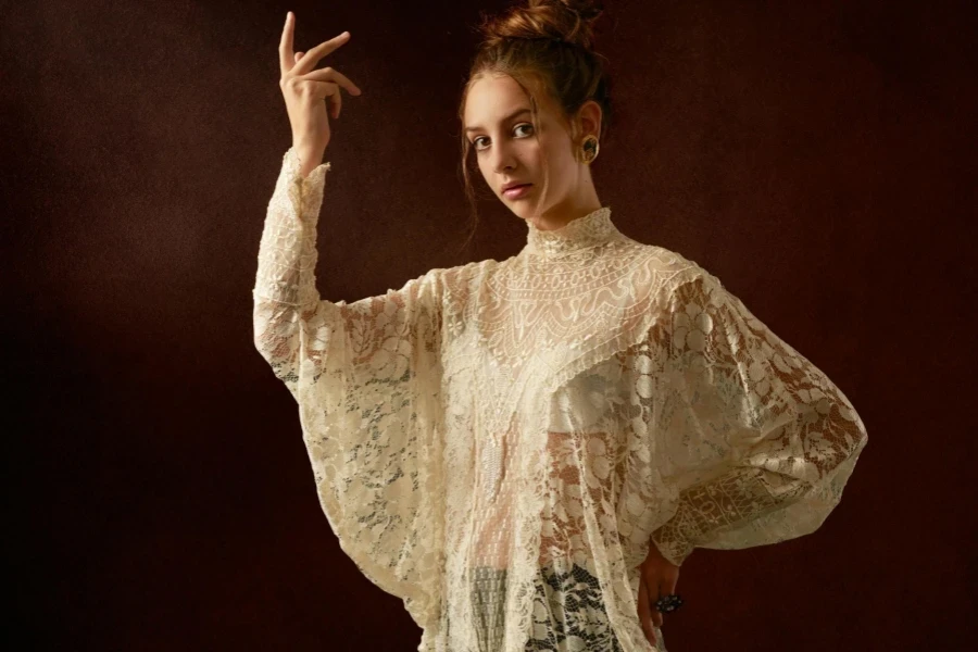 Female Model in Lace Unusual Blouse with Arm Raised