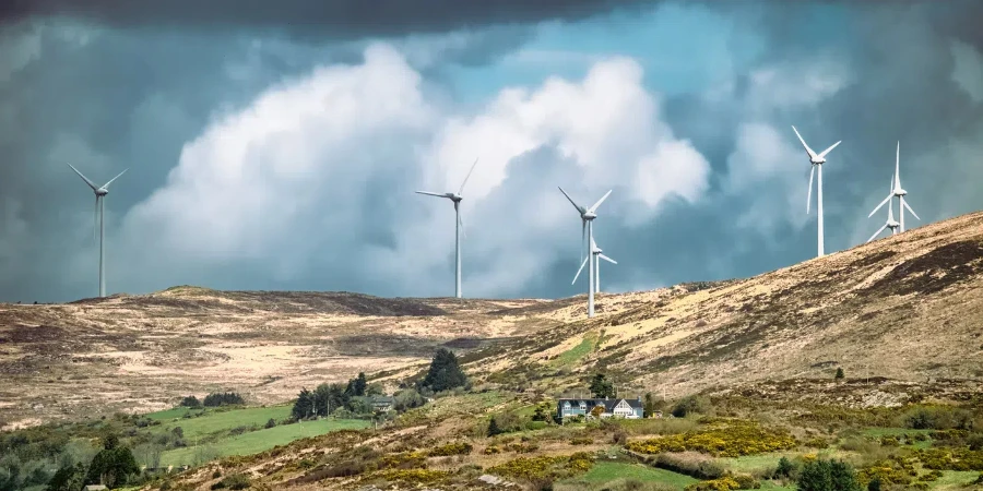 Few wind turbines stand tall on a hillside