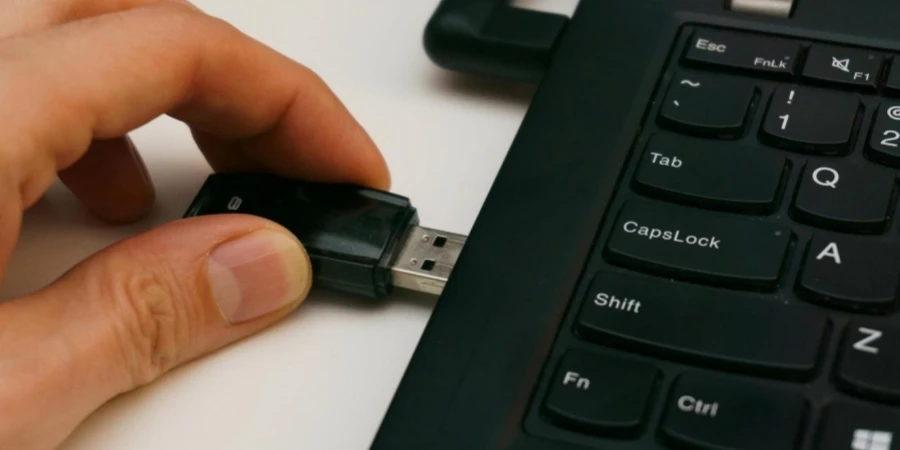 Fingers Putting Pen Drive into Laptop