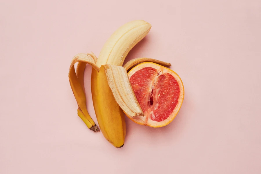 Fruits representing sexual health on a pink background