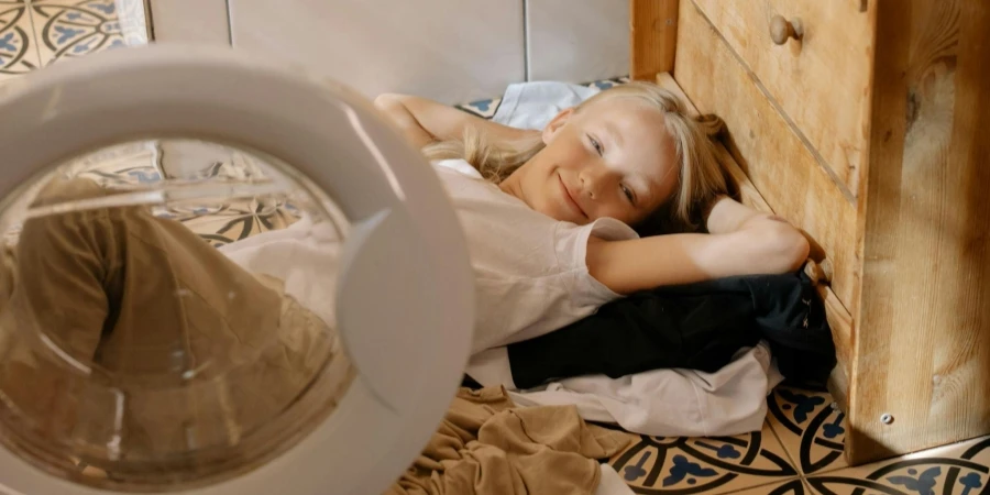 Girl Smiling while Lying on the Floor