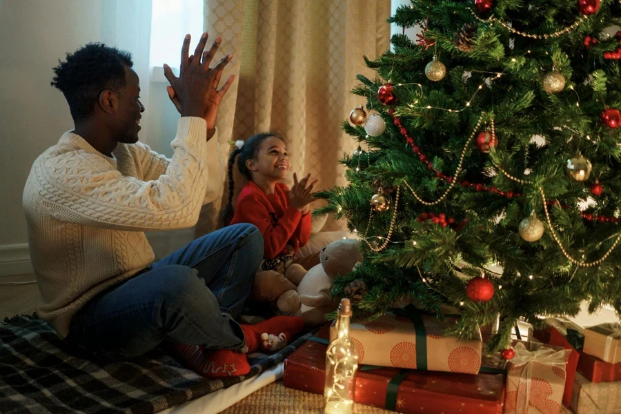 Girl and Her Father Singing Beside the Christmas Tree