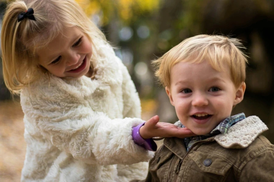 Girl holding boy's chin