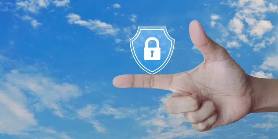 Hand pressing padlock with shield flat icon over blue sky with white clouds