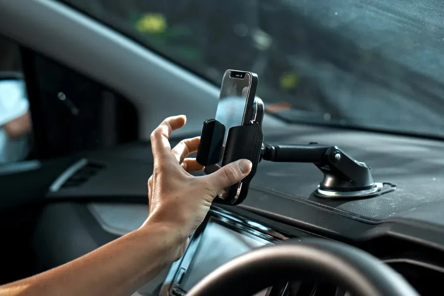 Hands of a young European girl sitting in a car with a black interior