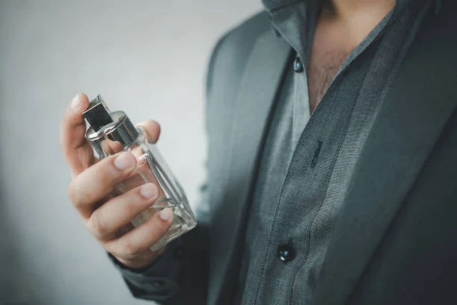 Handsome Man in Suit Using Perfume