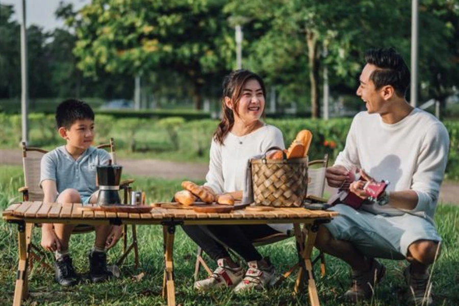 Happy family enjoying guitar music on camping day