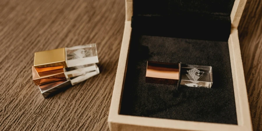 High angle of pile of modern pen drives against wooden box for gift on rough surface