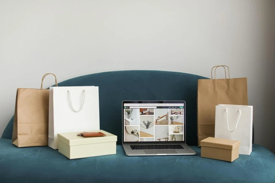 Macbook Pro With Shopping Bags and Boxes On Blue Couch