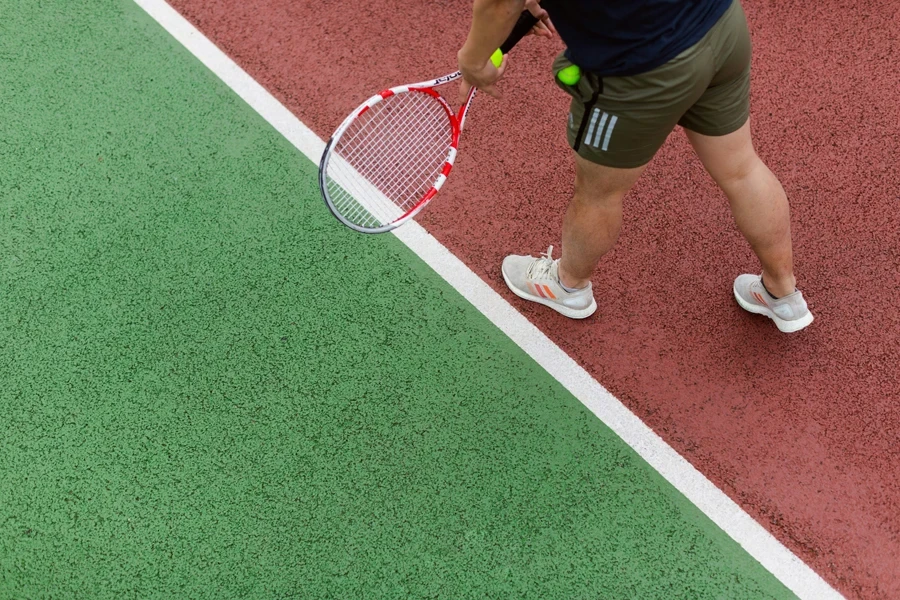 Male sports engineer tests tennis equipment