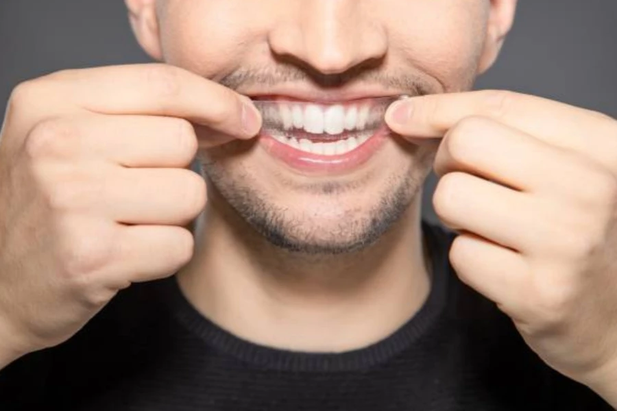 Man Apply Whitening Strip