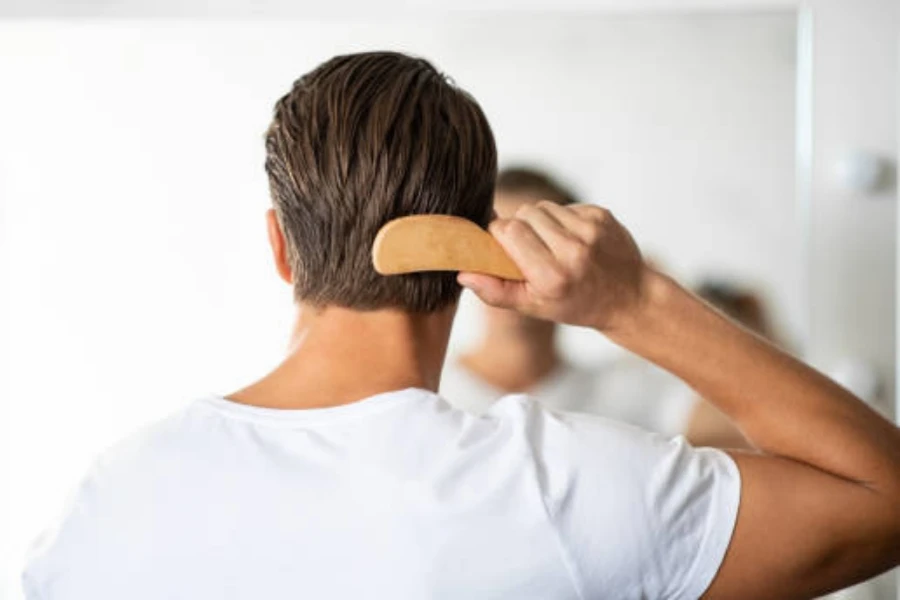 Man Looking in the Mirror Brushing Hair