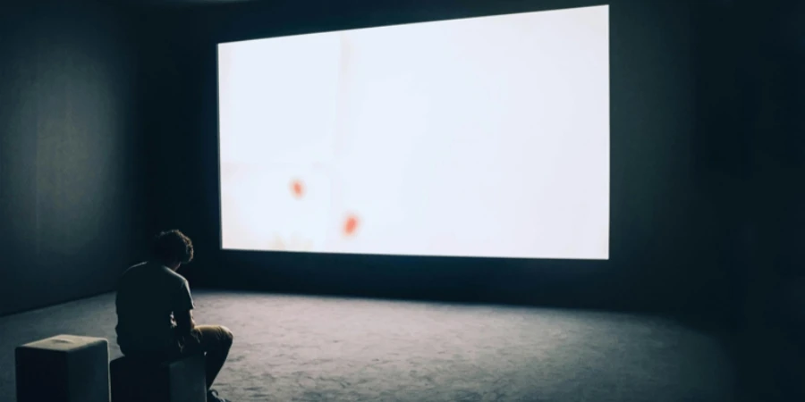 Man Sitting in Front of Turned-on Screen