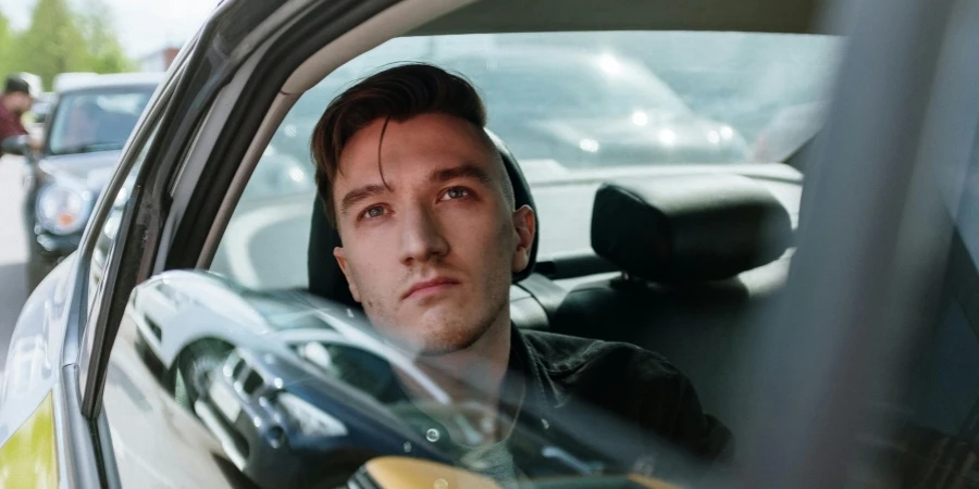 Man in Green Jacket Driving Car