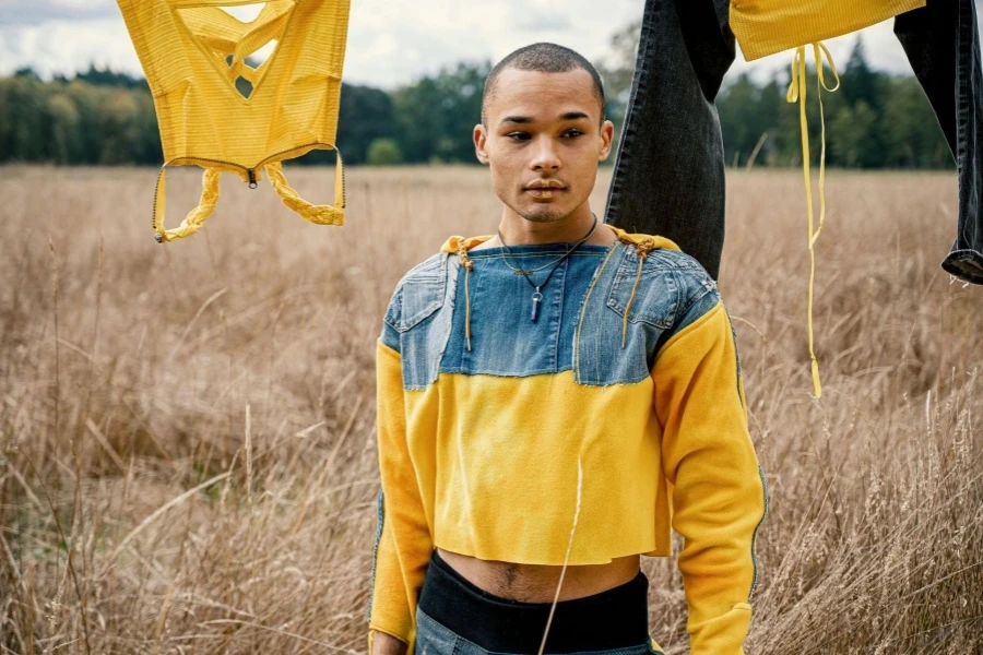 Man in Yellow and Blue Jacket Standing Outdoors