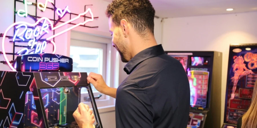 Man playing on a Coin Pusher in his mancave